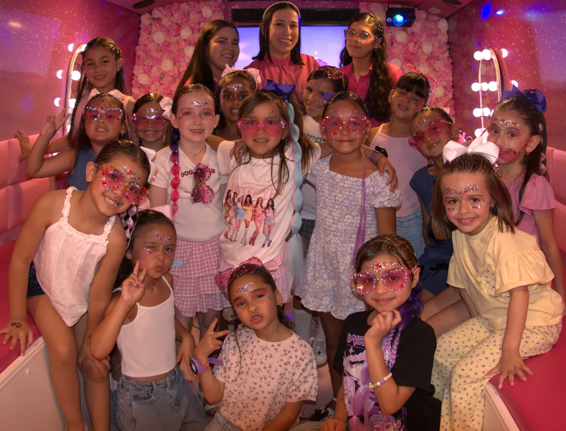 Children enjoying a Pink Spa Bus party inside the bus